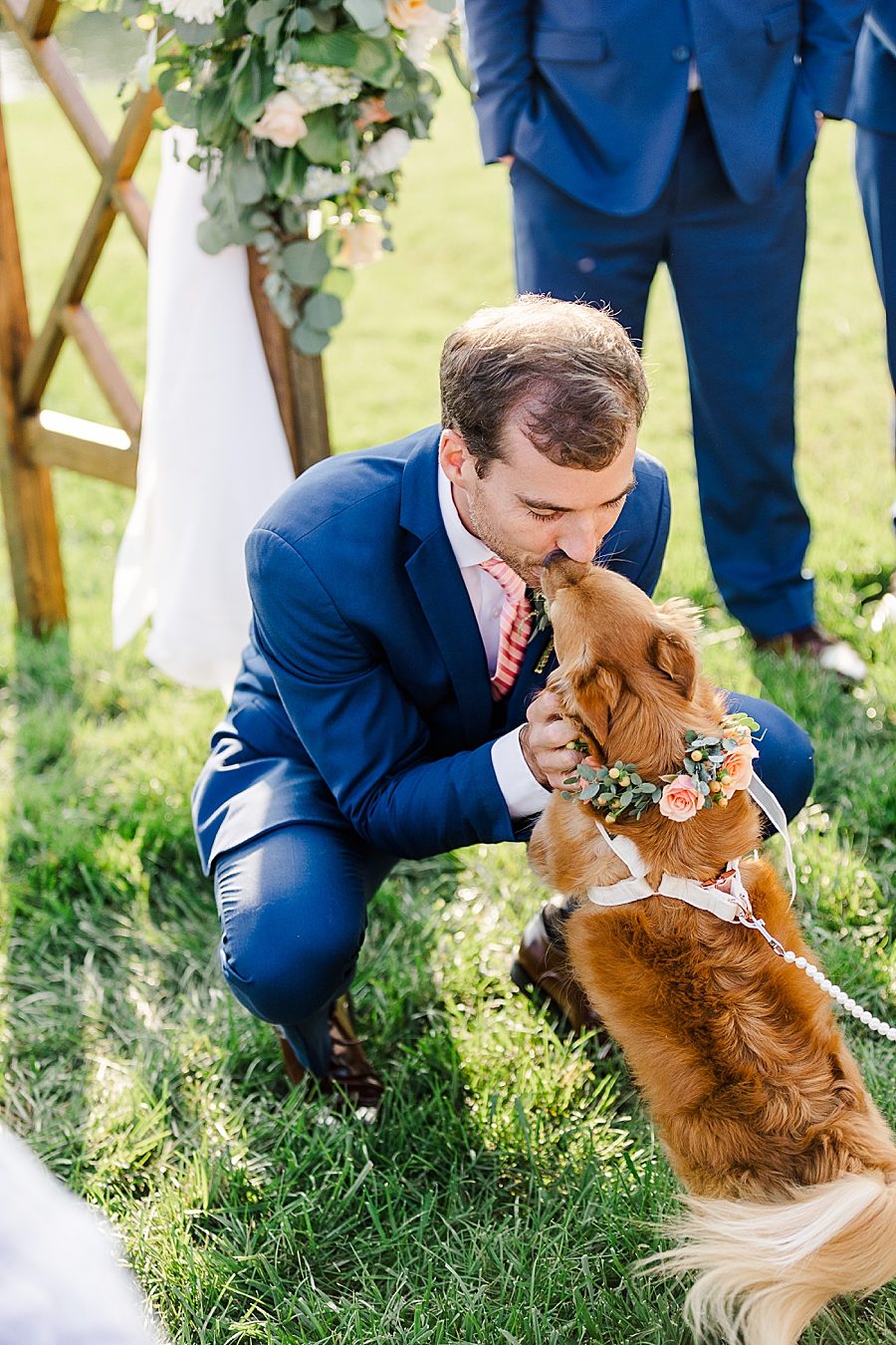 dog licking groom at this windriver wedding