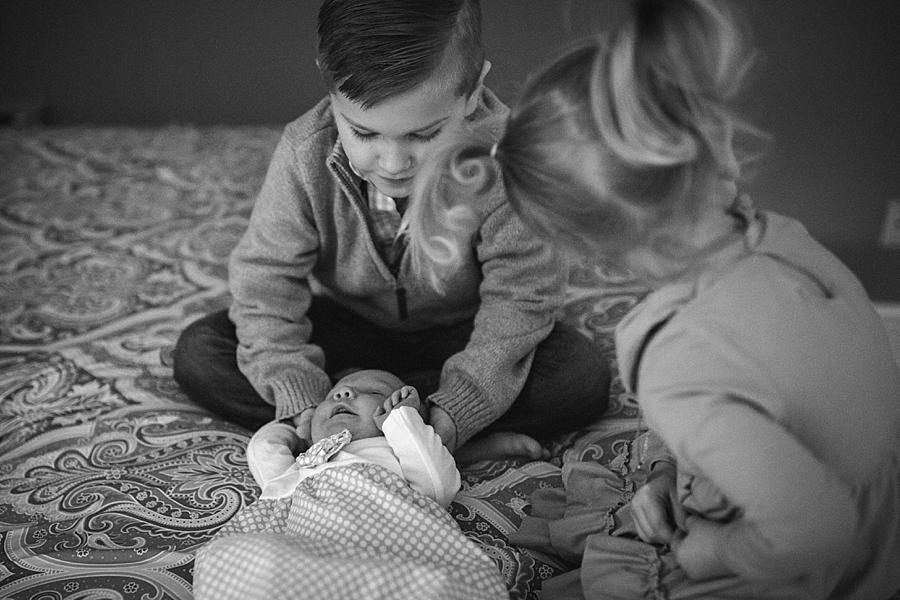 Brother and sister touching baby at this lifestyle family session by Knoxville Wedding Photographer, Amanda May Photos.