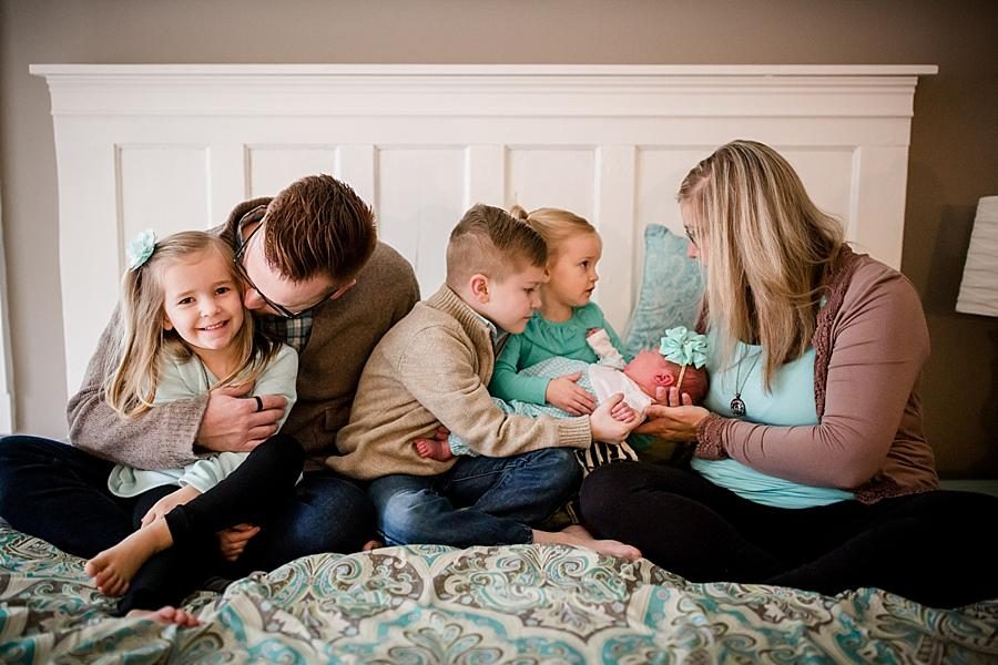 Sitting on the bed interacting at this lifestyle family session by Knoxville Wedding Photographer, Amanda May Photos.