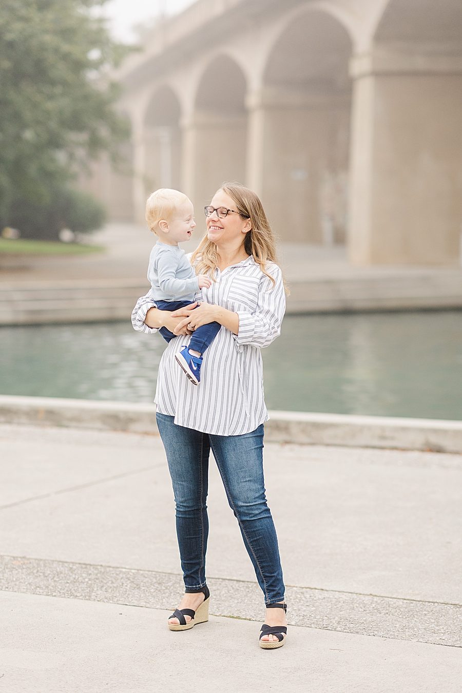 mom holding son at this world's fair site sunrise maternity session