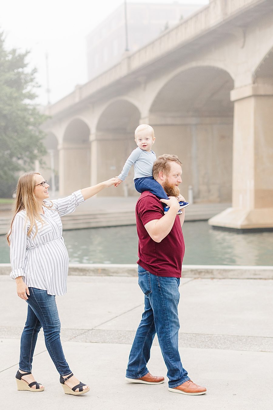 mom holding son's hand at this world's fair site sunrise maternity session