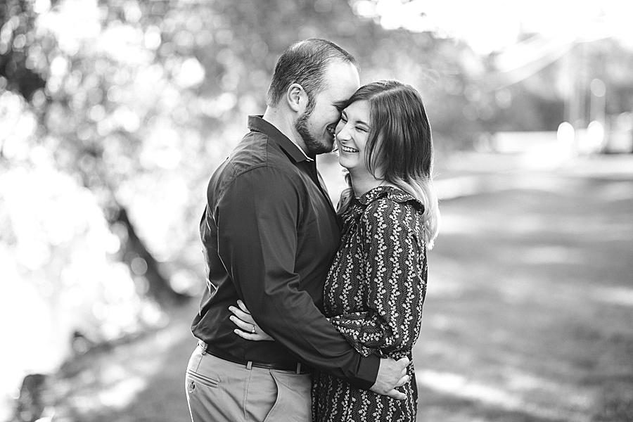 Whispering in her ear at this Apple Barn Engagement by Knoxville Wedding Photographer, Amanda May Photos.
