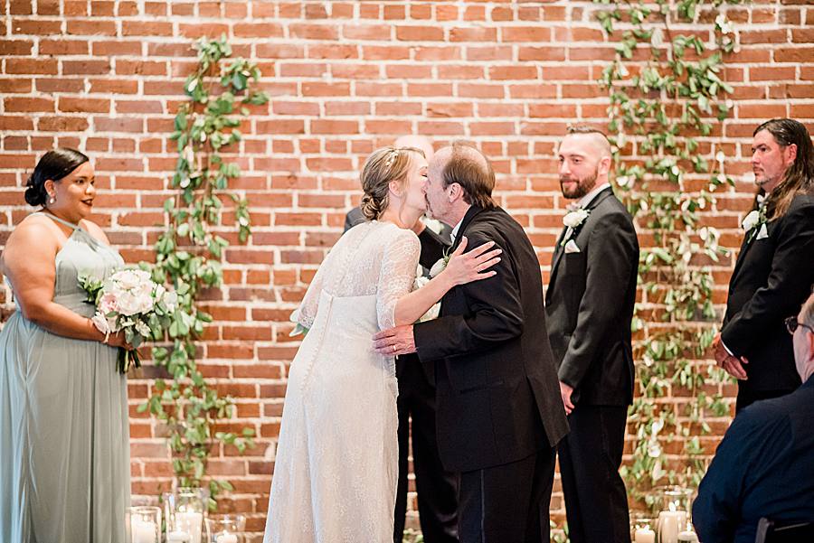 bride kissing father by associate photographer