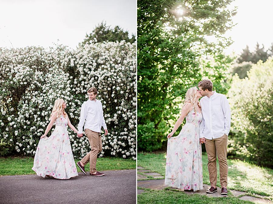 White spring blooms behind engaged couple