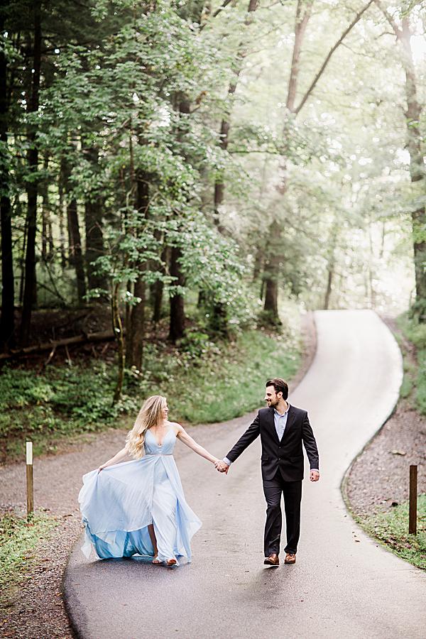 walking down paved path at cades cove engagement session