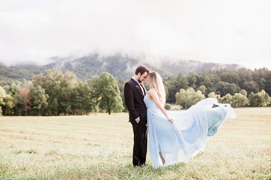 dress flowing in the wind at cades cove engagement session
