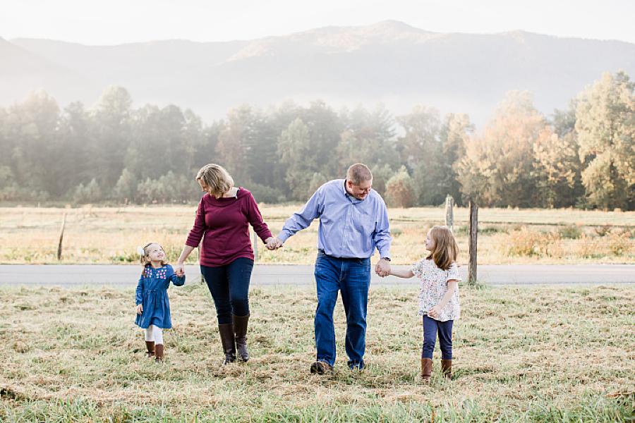 holding hands and walking Cades Cove family
