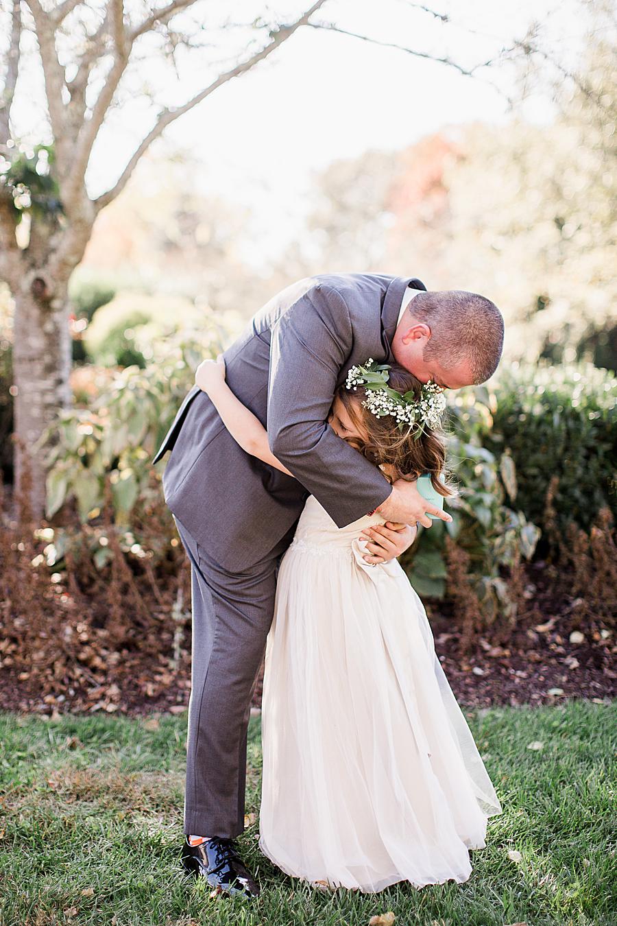 Hugging the flower girl at this Wedding at Castleton Farms by Knoxville Wedding Photographer, Amanda May Photos.