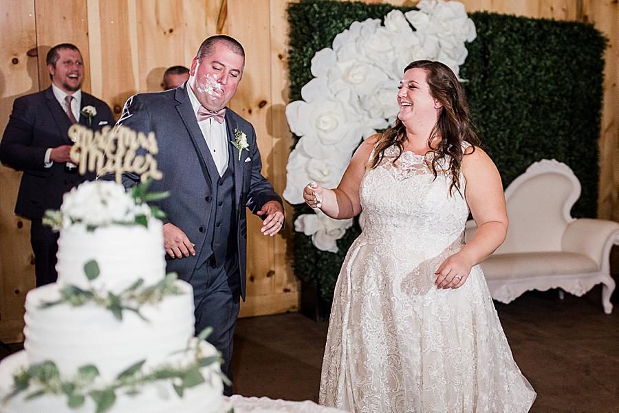 Cutting the cake at this Wedding at Castleton Farms by Knoxville Wedding Photographer, Amanda May Photos.