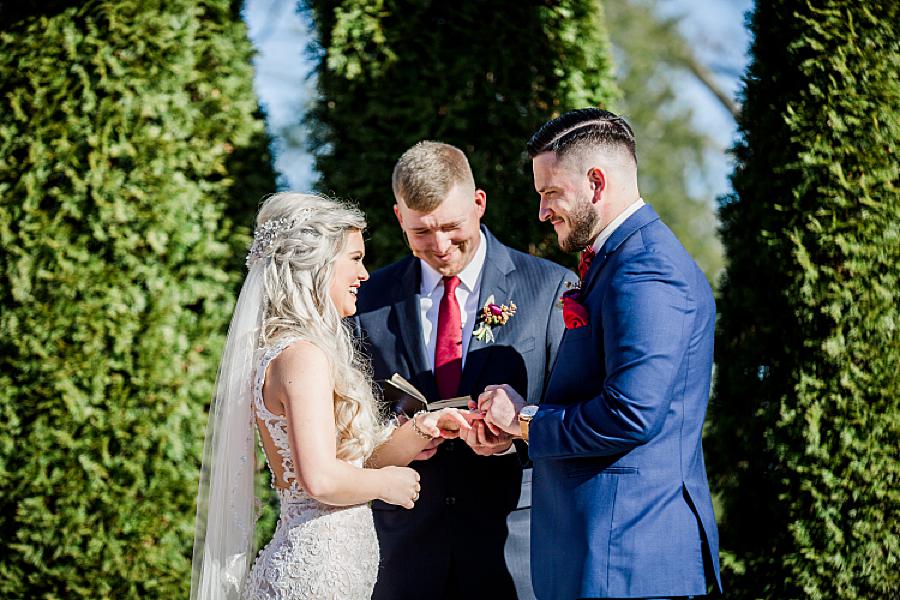 Exchanging rings at this Castleton Farms wedding