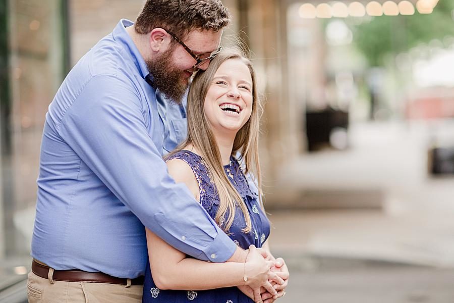 Arms wrapped around shoulders at this downtown engagement by Knoxville Wedding Photographer, Amanda May Photos.