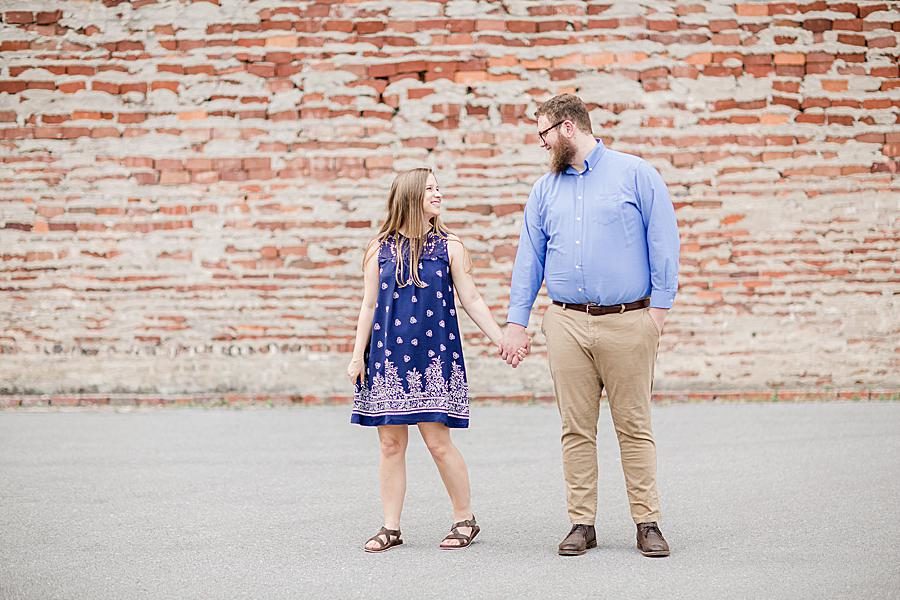 Holding hands at this downtown engagement by Knoxville Wedding Photographer, Amanda May Photos.