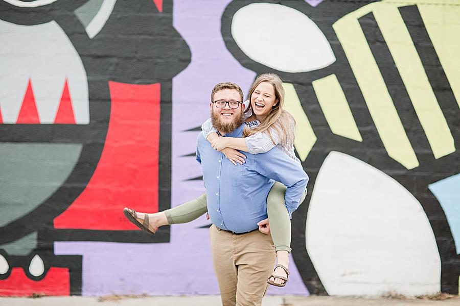 Piggyback at this downtown engagement by Knoxville Wedding Photographer, Amanda May Photos.