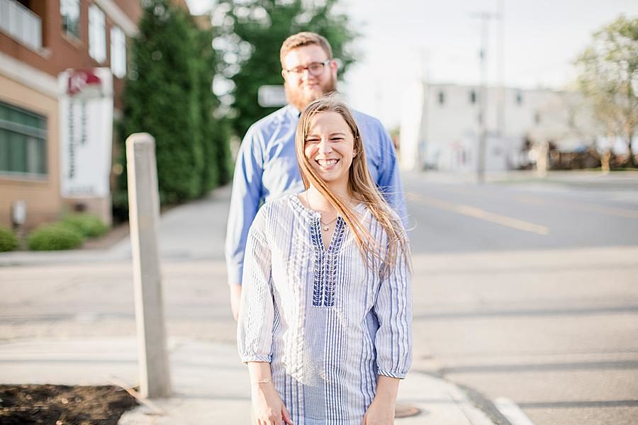 Standing together at this downtown engagement by Knoxville Wedding Photographer, Amanda May Photos.