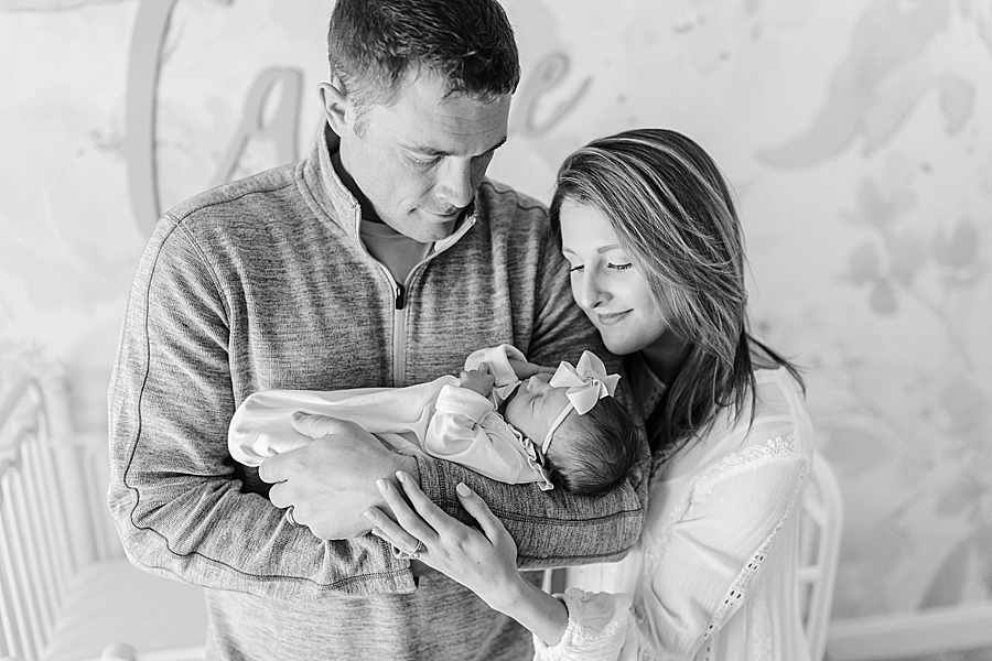 parents holding daughter dreamy newborn session