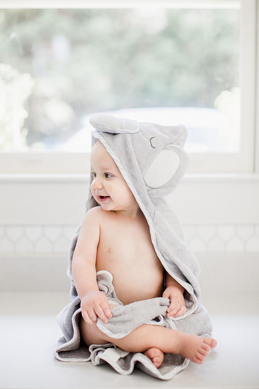 baby boy in elephant towel at fountain city 1