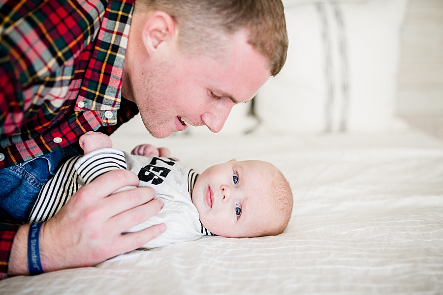 dad tickling son at fountain city 3 month session