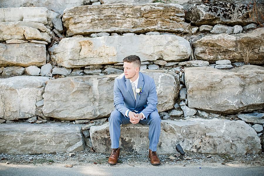 Groom sitting on quarry rocks at this Graystone Quarry wedding by Knoxville Wedding Photographer, Amanda May Photos.