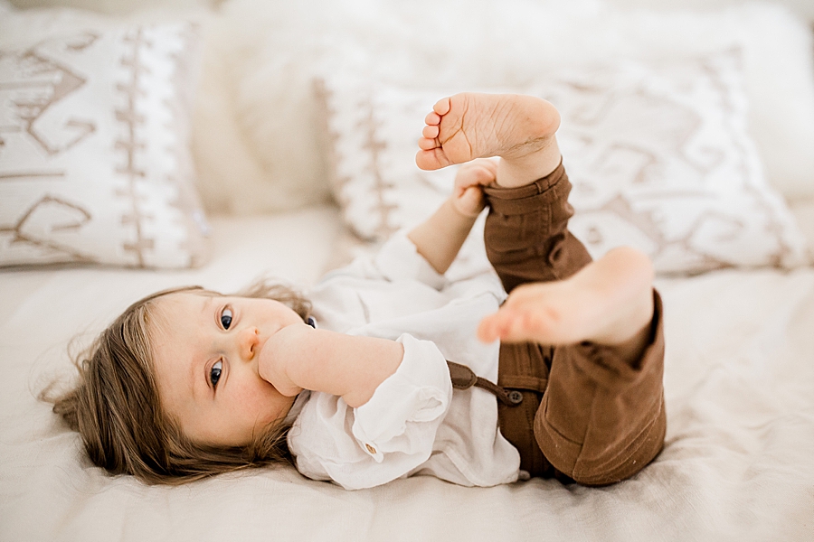baby playing with toes at home lifestyle