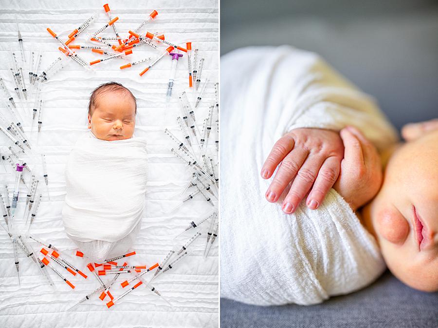 Baby surrounded by infertility treatment needles at knoxville newborn session