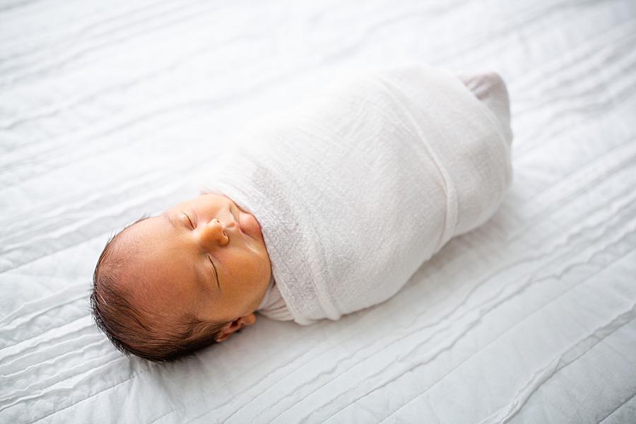baby in a white swaddle at knoxville newborn session
