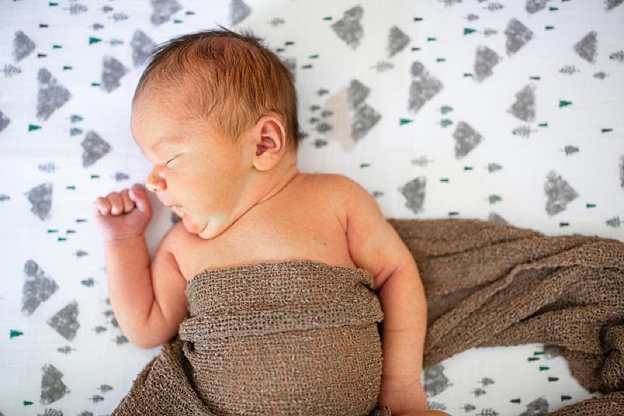baby wrapped in brown blanket at knoxville newborn session