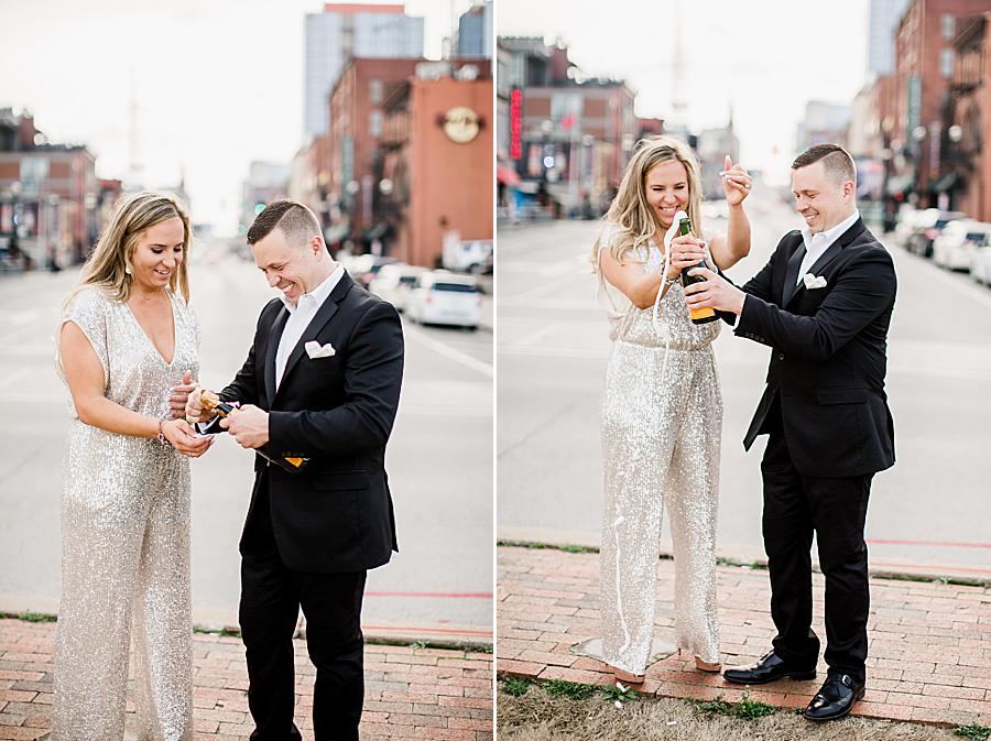 Couple popping champagne at Love Circle engagement