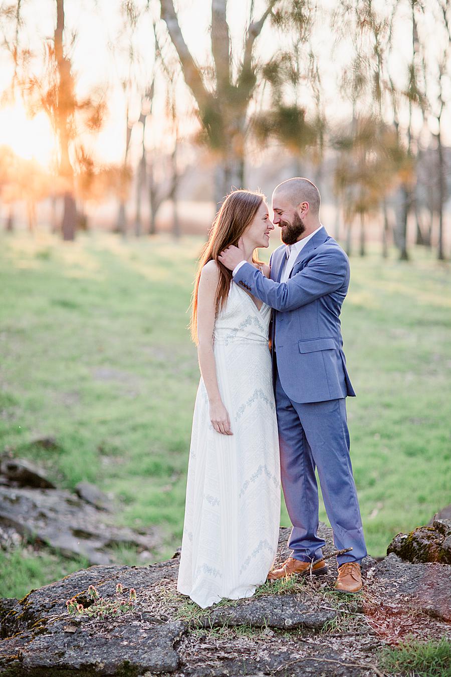 Brushing back hair at this Marblegate Farm engagement by Knoxville Wedding Photographer, Amanda May Photos.