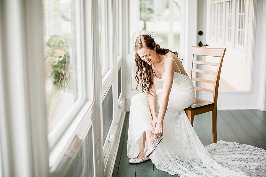 Putting on wedding shoes at this Marblegate Farm Wedding by Knoxville Wedding Photographer, Amanda May Photos.