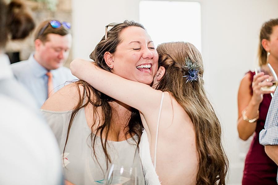 Bride hugging guest by Knoxville Wedding Photographer, Amanda May Photos.