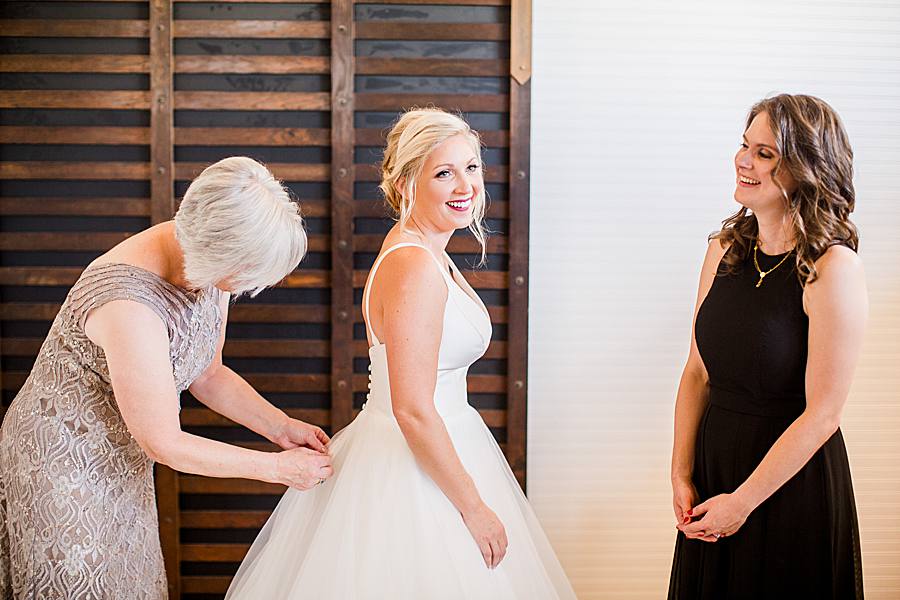 buttoning the bridal gown at the mill & mine