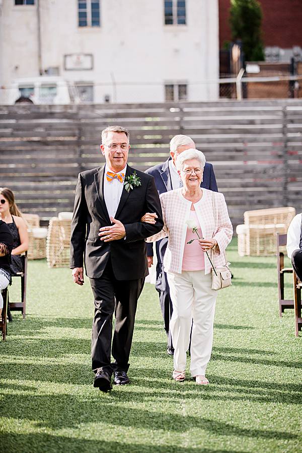 parents walking down the aisle at the mill & mine