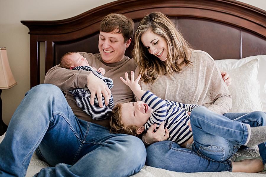 Laying in bed at this lifestyle newborn session by Knoxville Wedding Photographer, Amanda May Photos.
