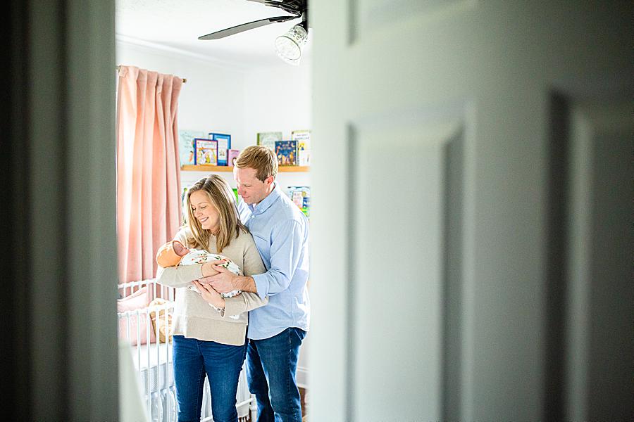 New family standing in baby's nursery