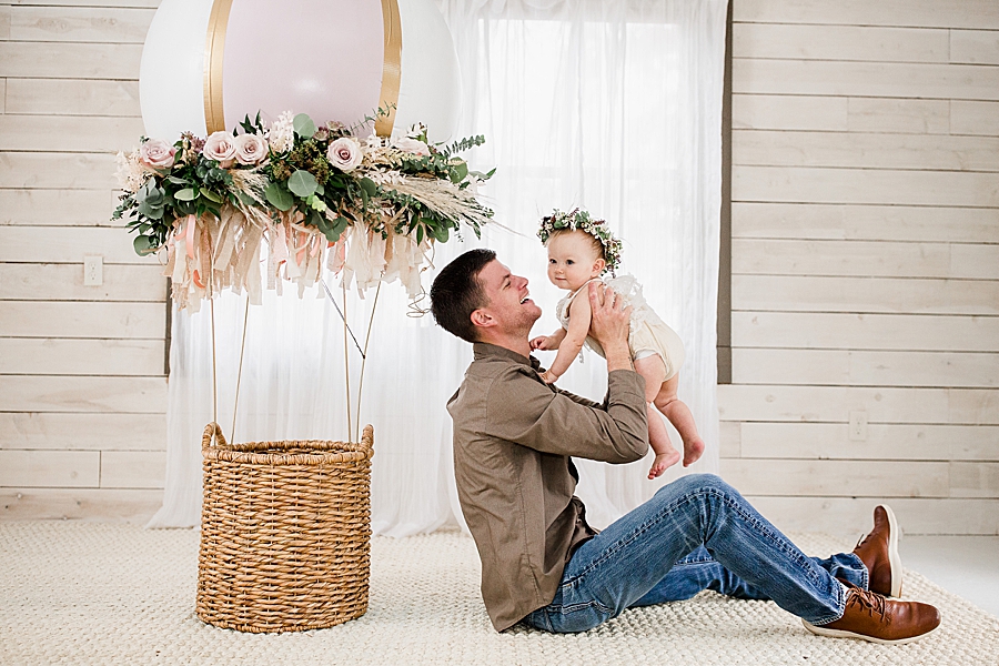 dad holding daughter one year session