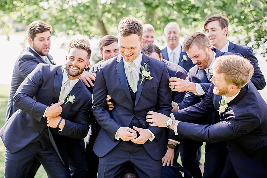 Groomsmen celebrating at this pavilion wedding by Knoxville Wedding Photographer, Amanda May Photos.