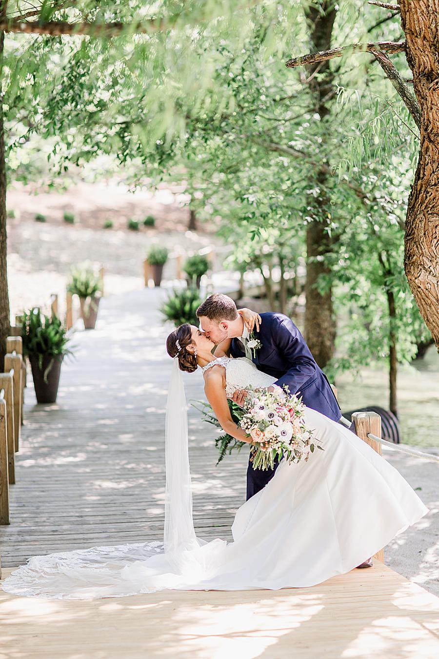 Dip kiss at this pavilion wedding by Knoxville Wedding Photographer, Amanda May Photos.