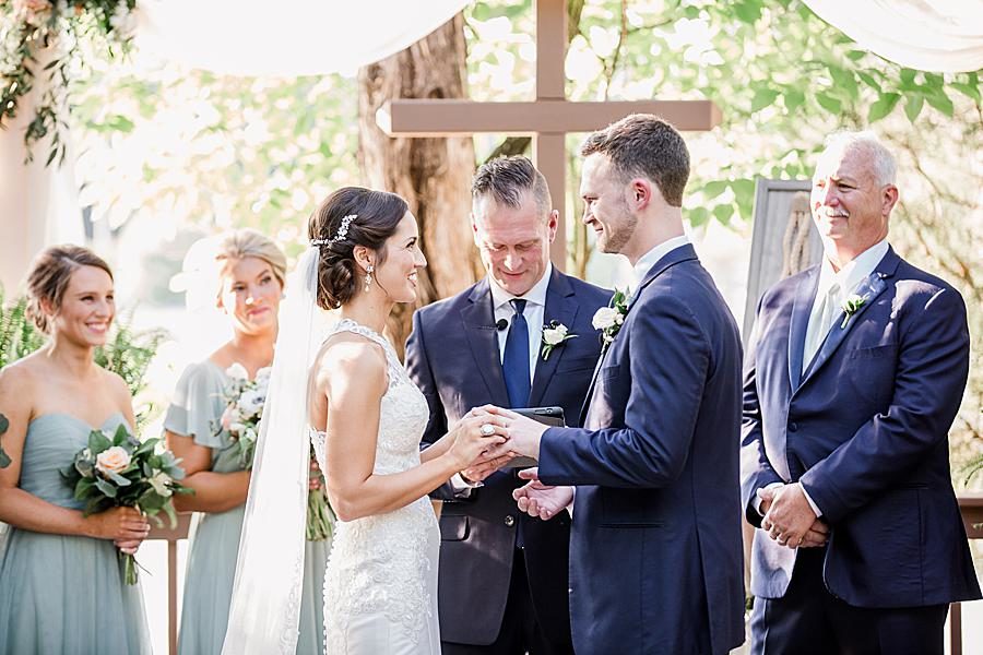 Exchanging rings at this pavilion wedding by Knoxville Wedding Photographer, Amanda May Photos.