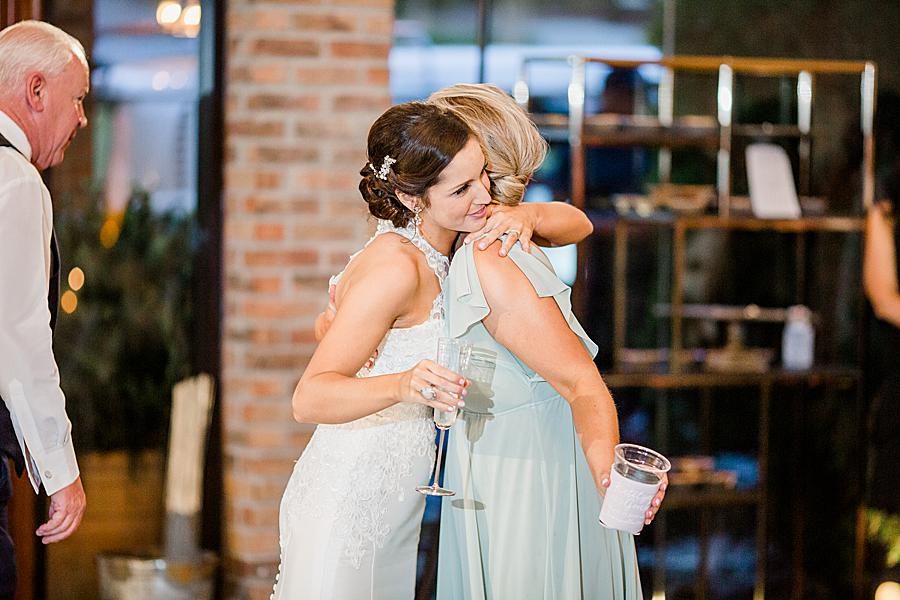Hugging guests at this pavilion wedding by Knoxville Wedding Photographer, Amanda May Photos.