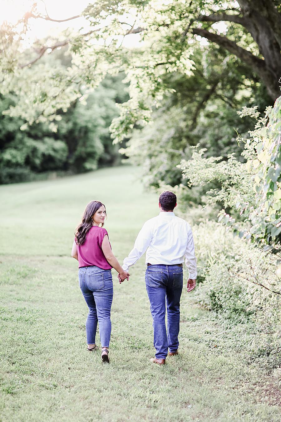 Holding hands and walking at this Percy Warner Engagement Session by Knoxville Wedding Photographer, Amanda May Photos.