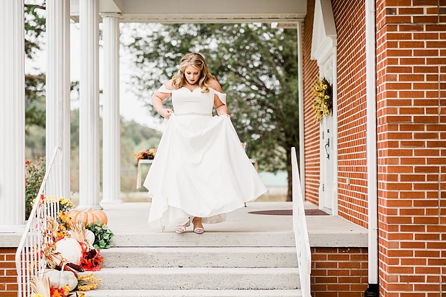 Walking down the stairs at this Pine Ridge Baptist Church wedding by Knoxville Wedding Photographer, Amanda May Photos.