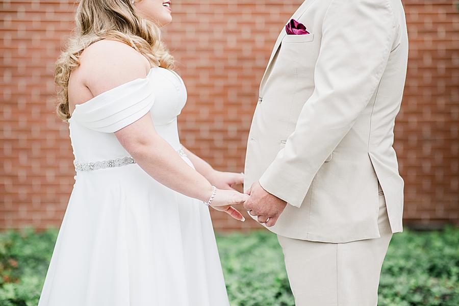 Holding hands at this Pine Ridge Baptist Church wedding by Knoxville Wedding Photographer, Amanda May Photos.
