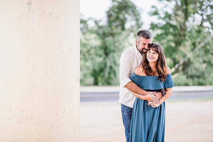 Hug from behind at this Printshop Brewery engagement by Knoxville Wedding Photographer, Amanda May Photos.