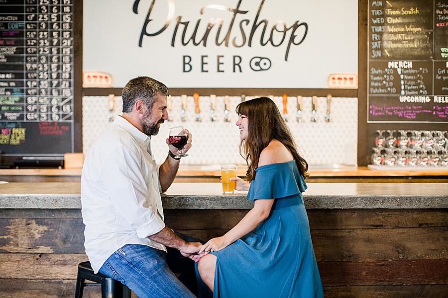 Drinking beer at this Printshop Brewery engagement by Knoxville Wedding Photographer, Amanda May Photos.