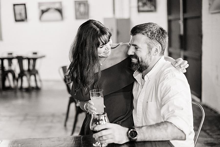 Sitting on his lap at this Printshop Brewery engagement by Knoxville Wedding Photographer, Amanda May Photos.