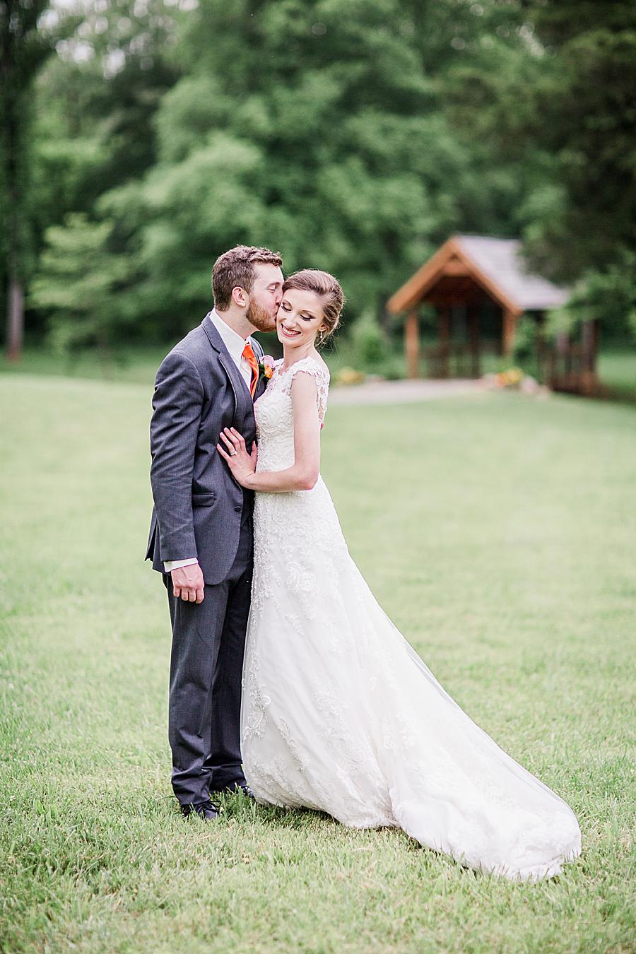 Kiss on the cheek at this Ramble Creek Vineyard Wedding by Knoxville Wedding Photographer, Amanda May Photos.