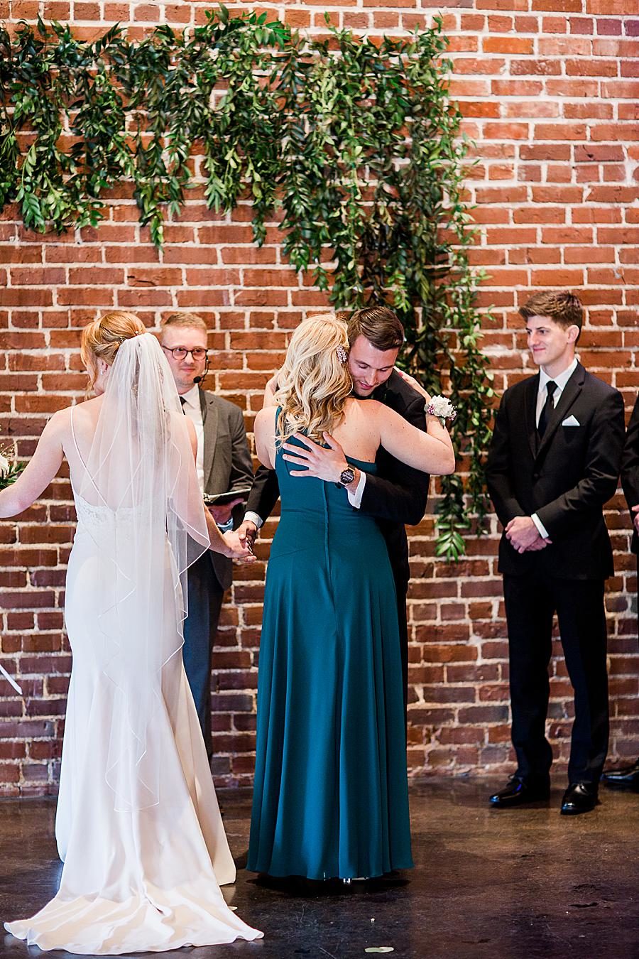 mother of the bride hugging the groom