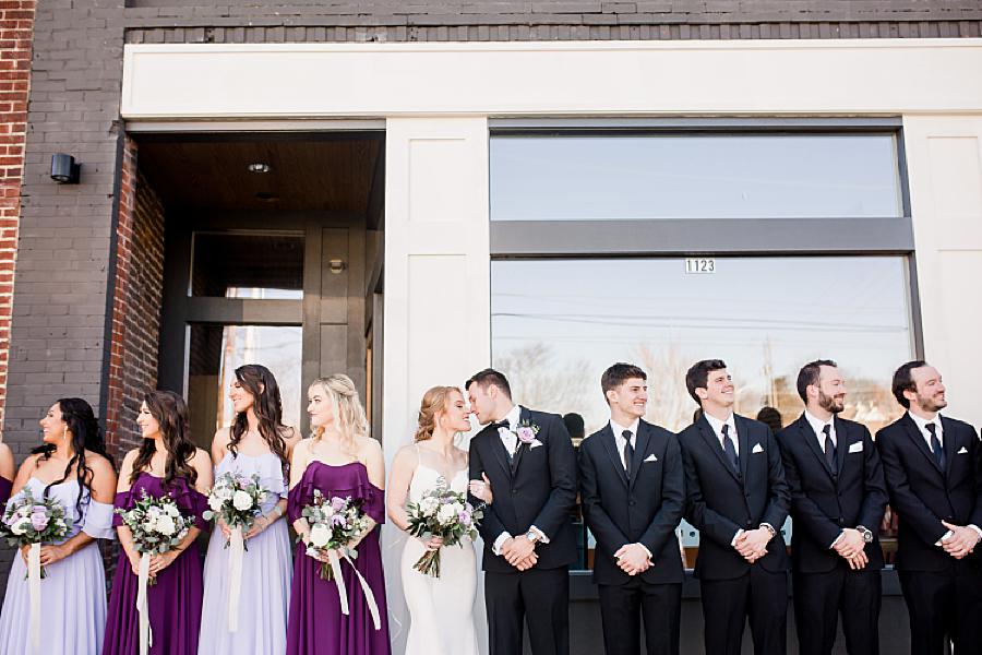bridal party looking away from bride and groom