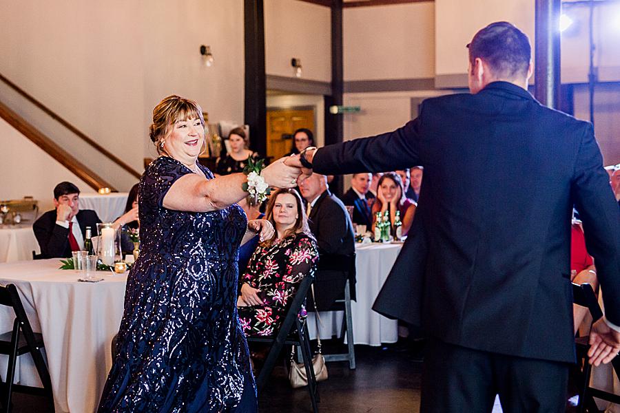 groom and mom dancing together at wedding