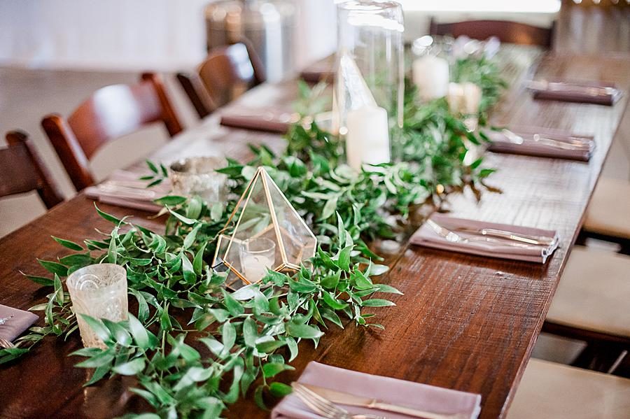 Greenery centerpieces at this RiverView Family Farm wedding by Knoxville Wedding Photographer, Amanda May Photos.